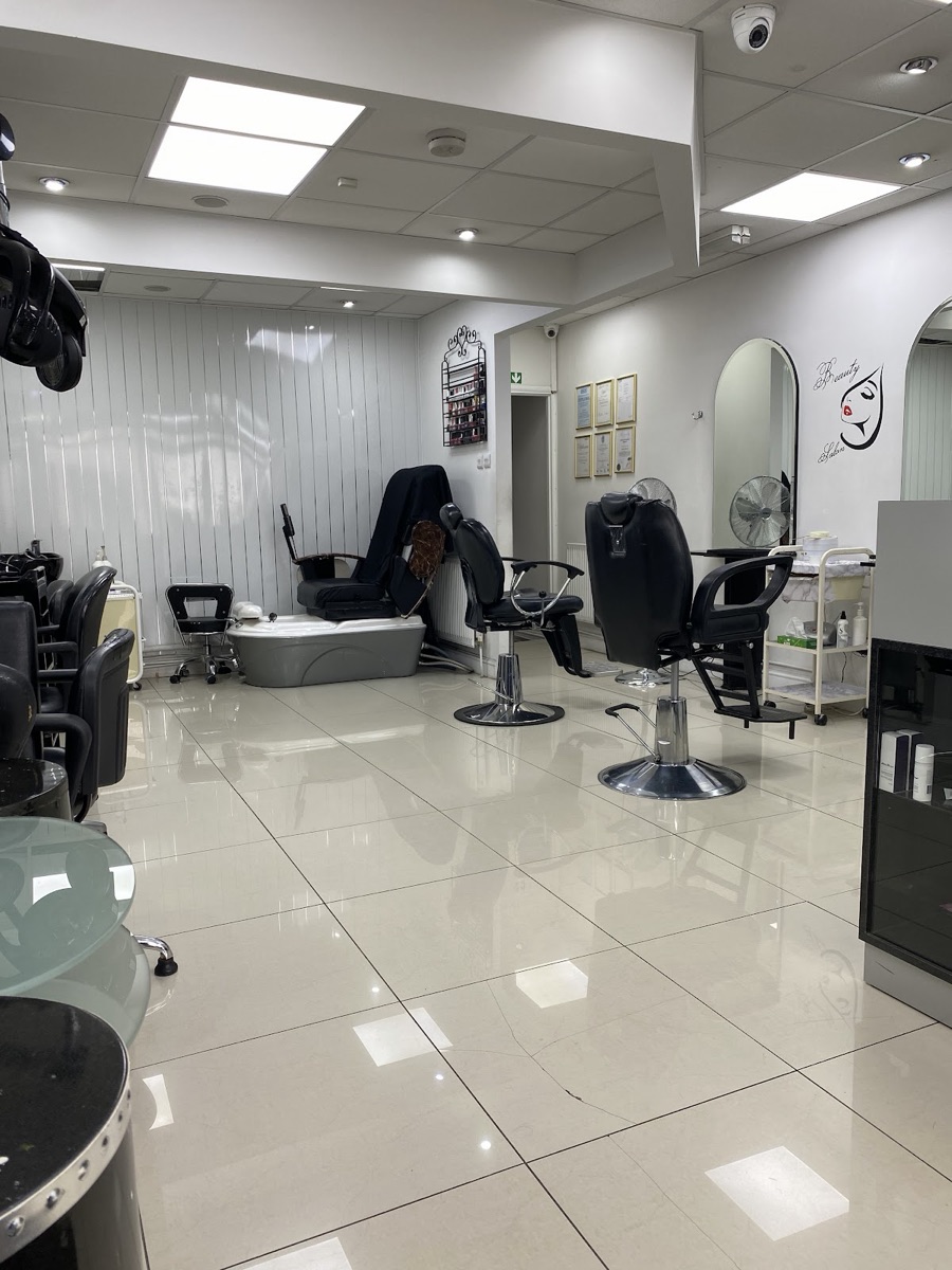 Inside Laiba Hair & Beauty — bright salon with styling chairs, mirrors and a pedicure station