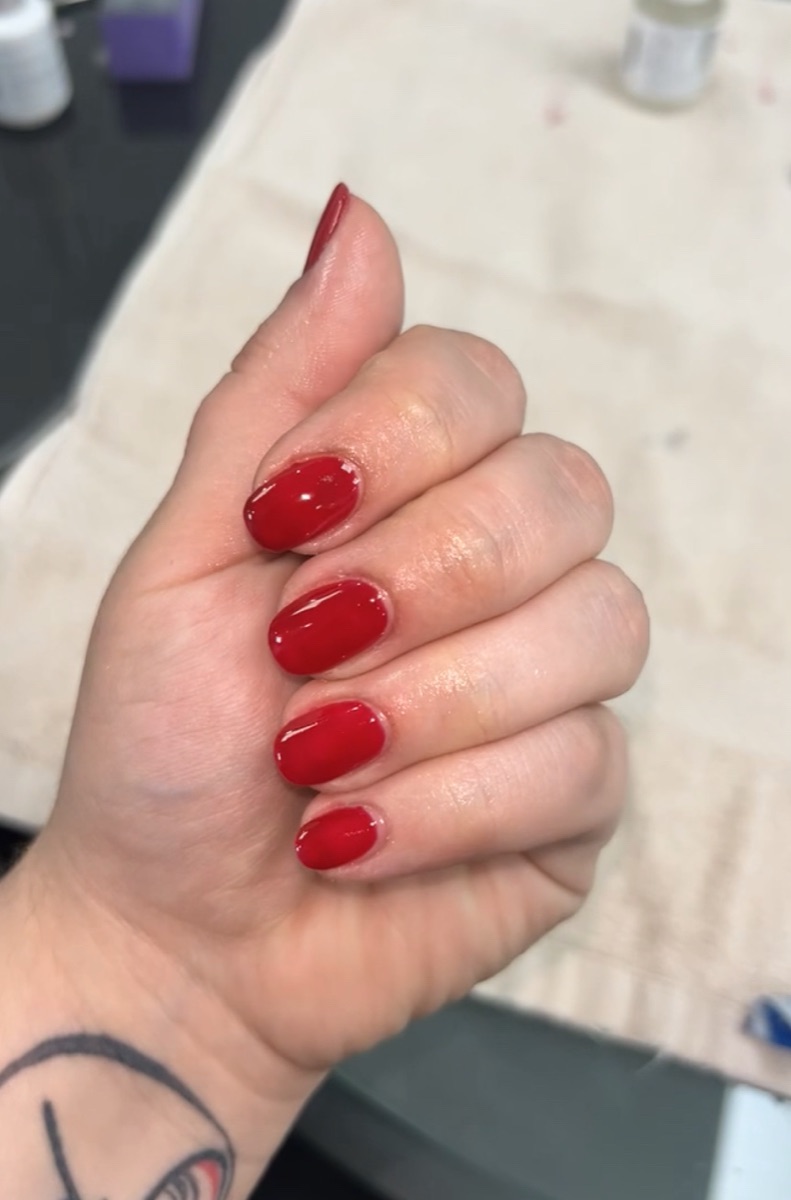 Glossy red gel manicure done at Laiba